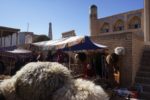 The inner walls of Khiva's Old Town are lined with vendors selling hats, jewelry and other Silk Route crafts. Photo credit: Jered Gorman
