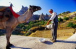 A camel ride is a memorable way to explore the moonlike rock landscape of Turkey's Cappadocia. Photo credit: Peter Guttman