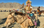 Proud young eagle hunter at Mongolia's Golden Eagle Festival. Photo credit: Michel Behar.