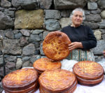 A vendor sells Armenian lavash bread outside Geghard Monastery. Photo credit: Devin Connolly