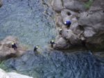Canyoners help each other over the rocks in the Cetina River Canyon. Photo credit: Iris Adventures