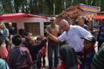 A MIR traveler shows local kids how to high-five. Photo credit: Russ Cmolik & Ellen Cmolik