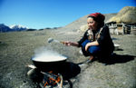 Meeting a local cooking dinner over a fire. Photo credit: Peter Guttman.