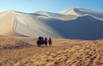 Taking a short camel ride in the Taklamakan Desert in Dunhuang, China.
