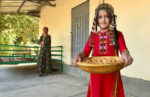 Young girl offering treats in Central Asia. Photo credit: Michel Behar
