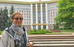 Patricia Schultz, author of 1,000 Places To See Before You Die, in front of Moldova's Parliament in Chisiniau, Moldova. Photo credit: Michel Behar