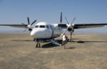Boarding a prop plane for a short flight in Mongolia. Photo credit: Martin Klimenta.