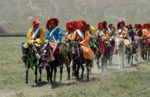 Parade of national dress at a local festival in Tibet. Photo credit: Phil Kidd.