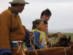 Two generations at a country Naadam festival. Photo credit: Andrew Barron