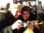 A MIR traveler shares her photos with a Margilan local. Photo credit: Michel Behar
