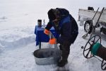 Ice-fishing with a net. Photo credit: Douglas Grimes