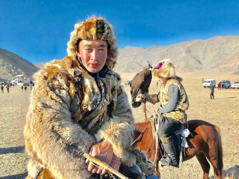 In between eagle events, eagle hunters and attendees enjoy festival games. Photo: Michel Behar