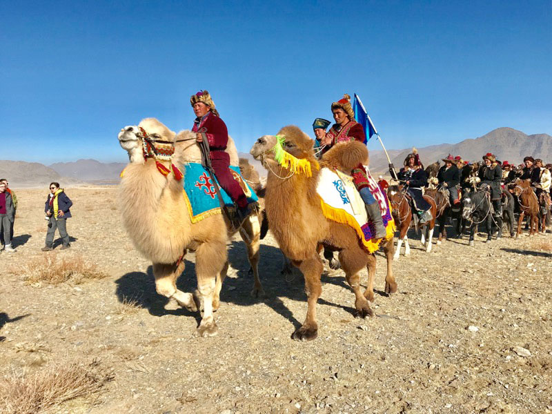 A parade of eagle hunters, kicking off Mongolia’s Golden Eagle Festival. Photo: Michel Behar