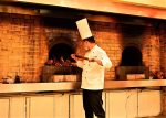 Chef puts a Peking Duck in an open oven, Beijing, China. Photo credit: Lifeng Liu