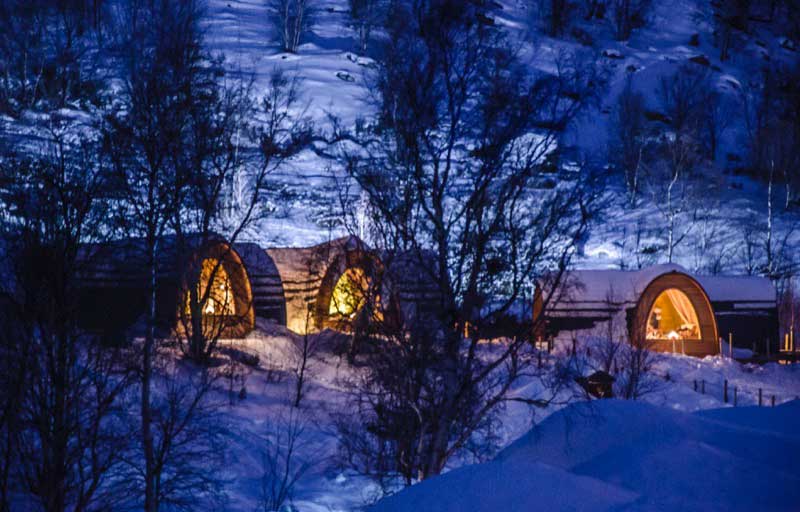 Guests can choose to stay in heated cabins modeled after the traditional dwellings of the Sami people. Photo credit: Kirkenes Snow Hotel / Nevra Pictures