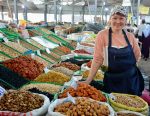 A woman selling dried fruit and nuts at a local market in Almaty, Kazakhstan. Photo credit: Timur Kaskenov
