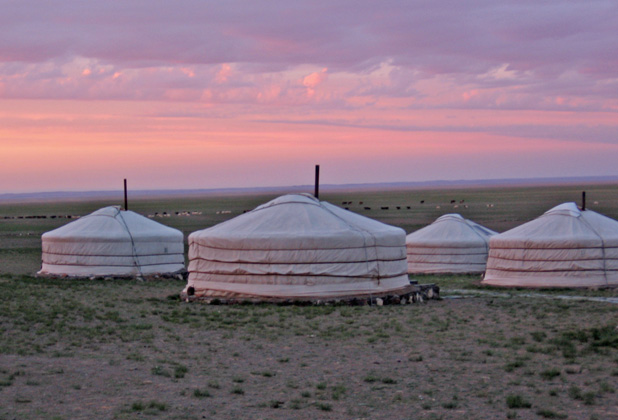 Mongolian steppe at sunset, with gers dotting the landscape. Photo credit: Andrew Barron