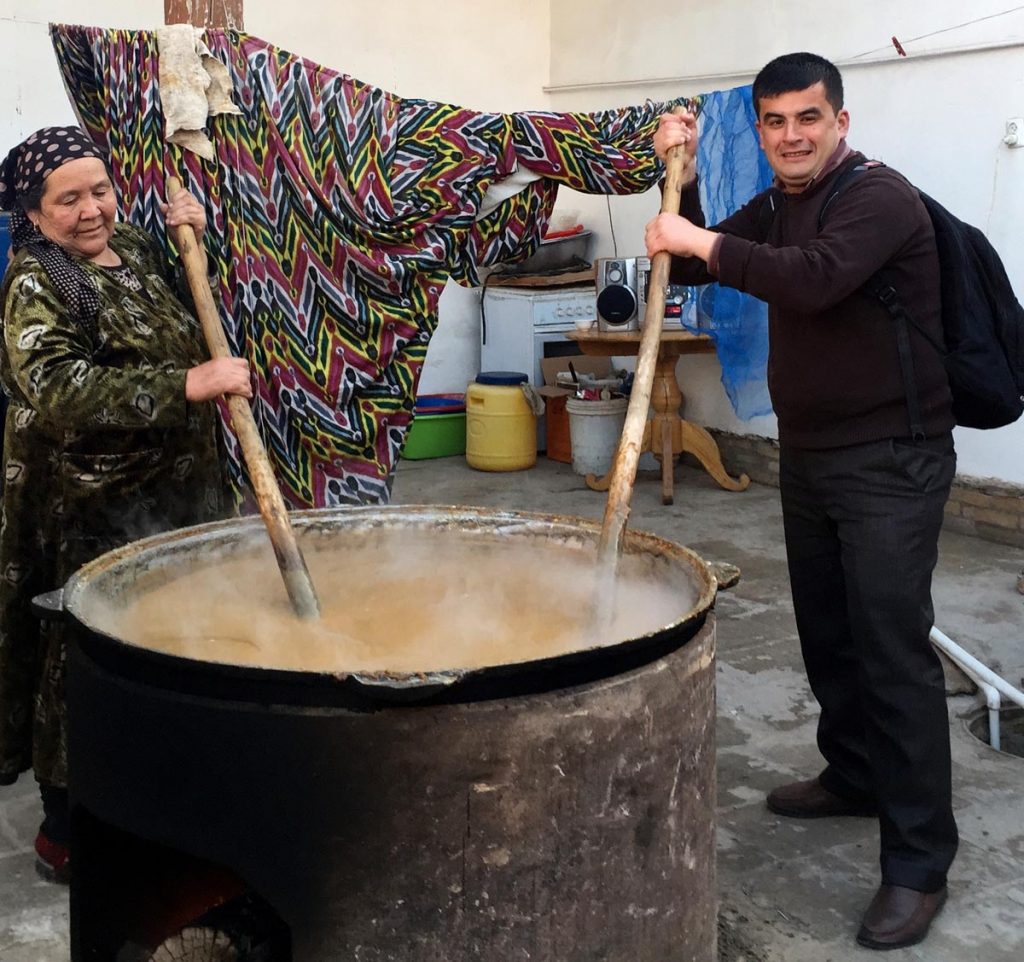 Abdu doing his part to help with the sumalak preparation. Photo credit: Abdu Samadov