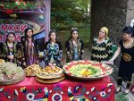 Tajik women present a large dish of traditional plov. Photo credit: Dilshod Karimov
