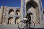 A cyclist pedals past Bukhara’s graceful Ulug Bek Madrassah. Photo credit: Jered Gorman