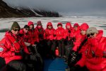 Travel pioneers in their expedition parkas aboard a Zodiac landing craft. Photo credit: Jonathan Zaccaria