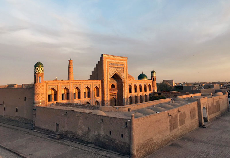 Sunlight highlights the magnificent blue majolica entrance portal of Muhammad Rahim-Khan Madrassah. Photo credit: Abdu Samadov