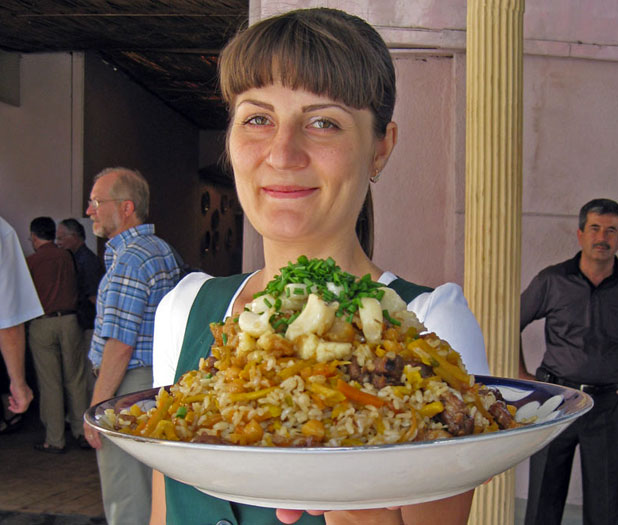 A favorite Uzbek dish, UNESCO-listed plov is mounded high for a festive luncheon in Tashkent. Photo credit: Helen Holter
