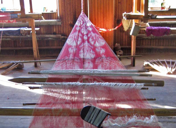 A silk loom stretches from wall to wall in Margilan, Uzbekistan. Photo credit: Paul Schwartz