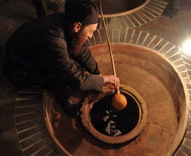 An Alaverdi winemaker using an ancient qvevri to make Georgian wines. Photo credit: John Wurdeman