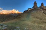 Day breaks over Mount Kazbek and Tsiminda Sameda Church near Kazbegi, Georgia. Photo credit: James Carnehan
