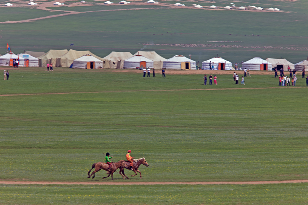 Horse racing with Mongolian gers as backdrop at UlaanBaatar’s Naadam Festival. Photo credit: Helge Pedersen
