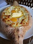 It's not hard to see why many travelers to Georgia are quick to fall in love with their version of pizza - Adjaran khachapuri. Photo: John Wurdeman