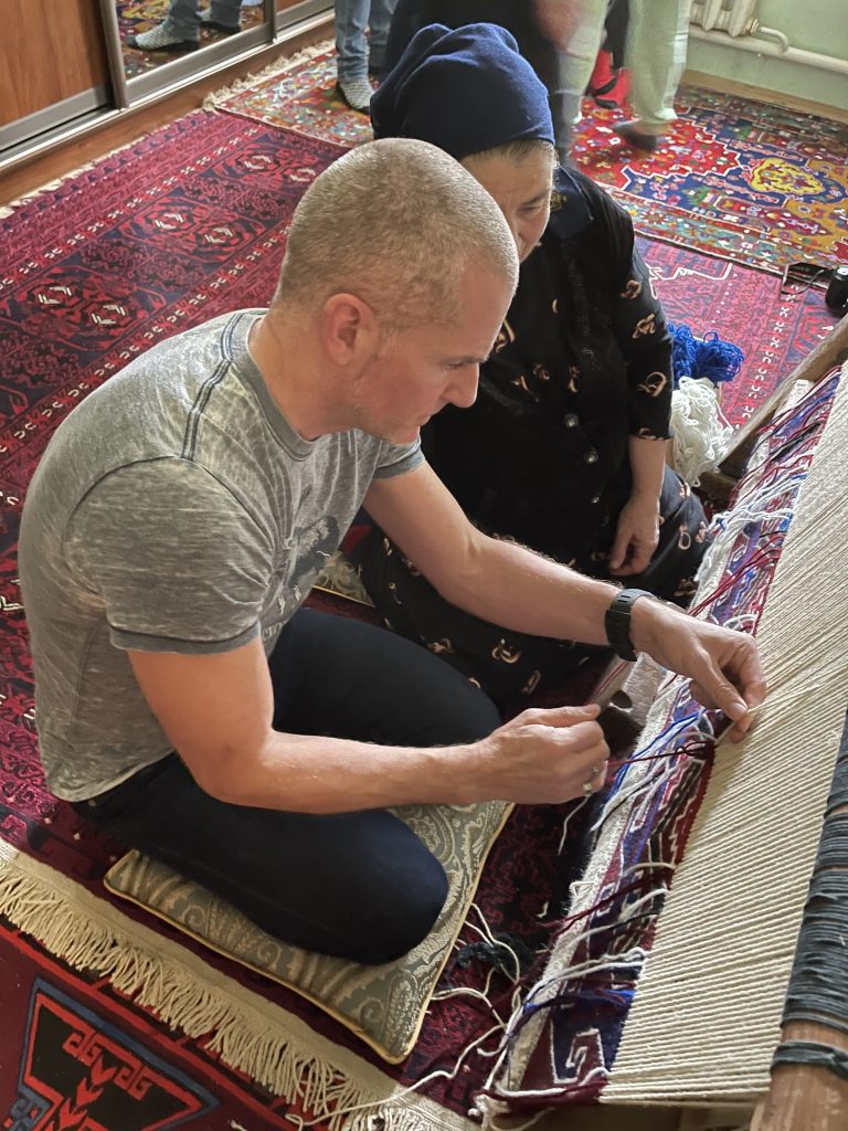 John learning to weave a carpet in Dagestan. Photo credit: John Seckel