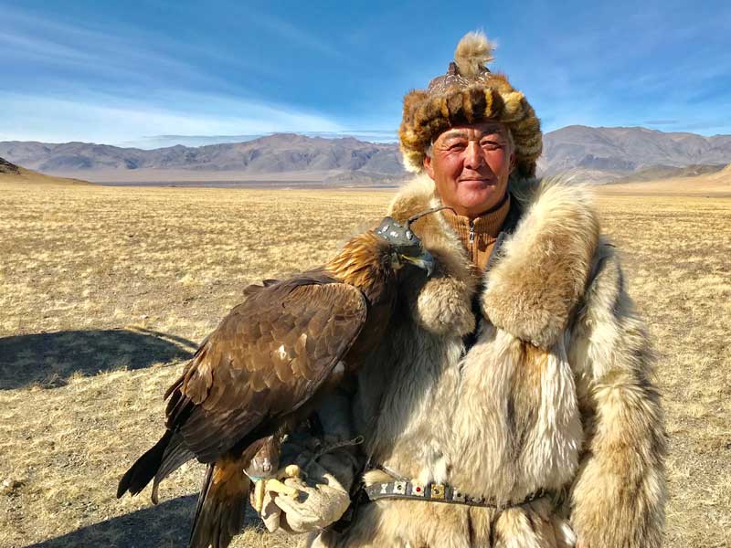 A Kazakh berkutchi, or eagle handler, and his hunting companion. Photo credit: Michel Behar