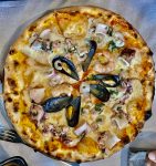 Delicious seafood pizza in Saranda, Albania. Photo credit: Michel Behar
