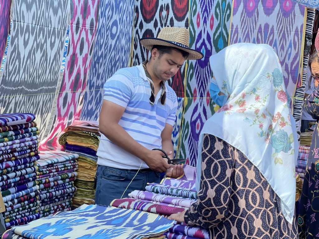 Buying fabric at the bazaar in Bukhara, Uzbekistan. Photo credit: Abdu Samadov