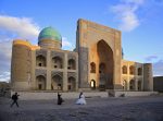 Historic sites like the Mir-i-Arab Madrassah in Bukhara are popular spots for wedding photos, Uzbekistan. Photo credit: Ann Schneider