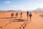 Riding camels through Wadi Rum. Photo credit: Jordan Tourism Board