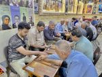 Men playing backgammon at a cafe in Baghdad. Photo credit: Michel Behar